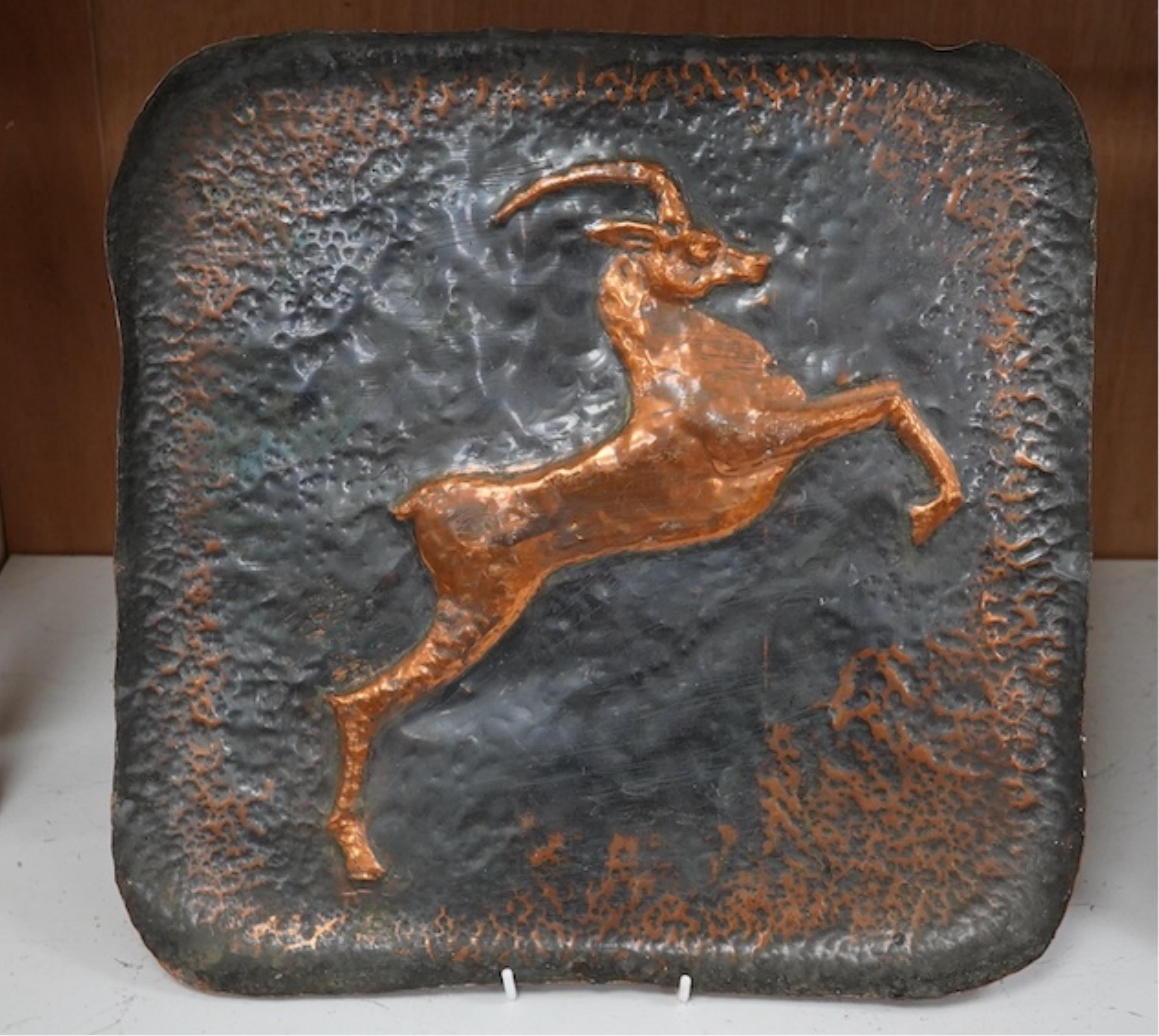 A pair of planished copper trays, one of an Impala and the other a Lion. 39.5cm square. Condition - fair